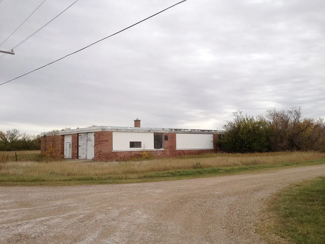 Abandoned brick building on a gravel road, 2013