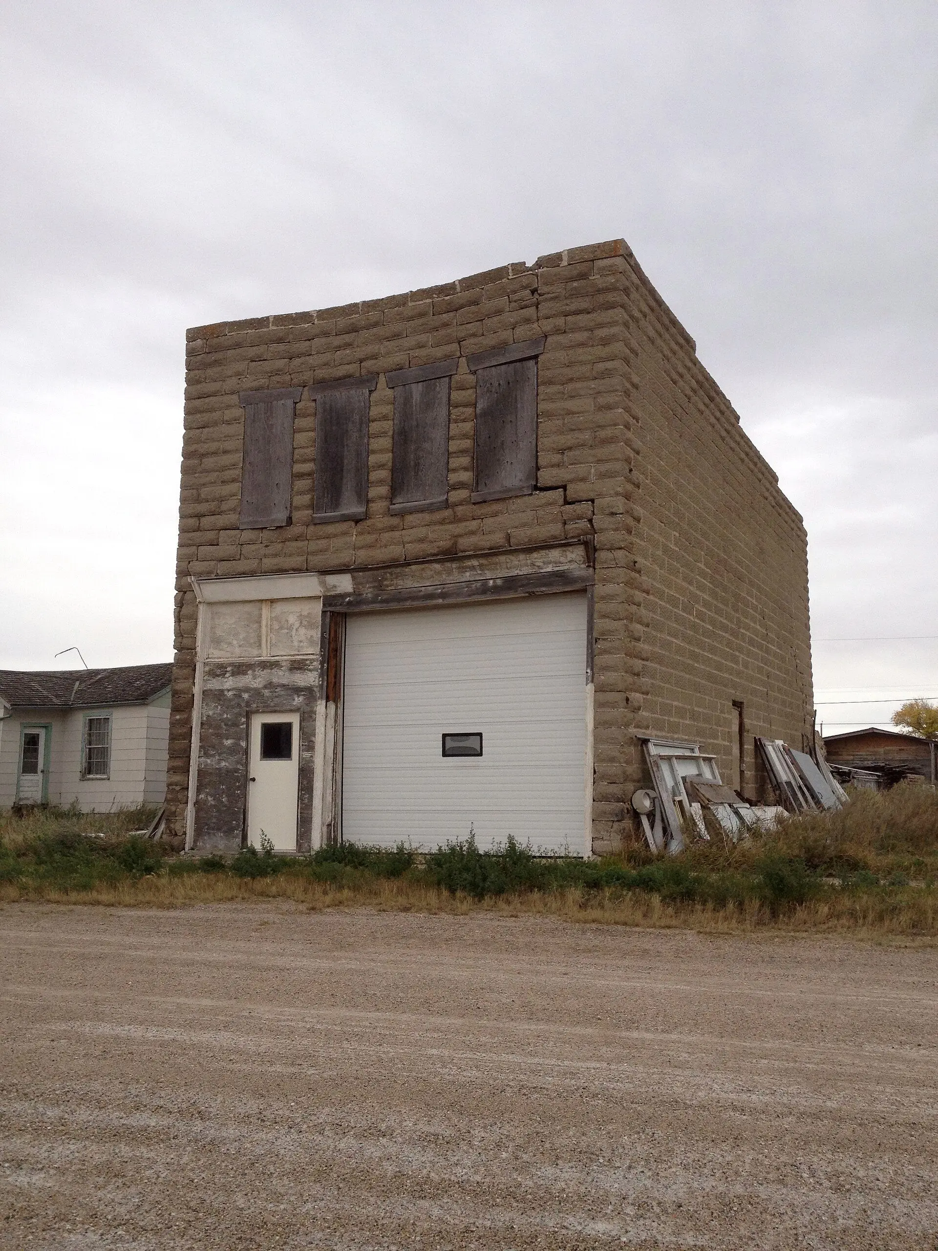 Abandoned brick building with boarded windows