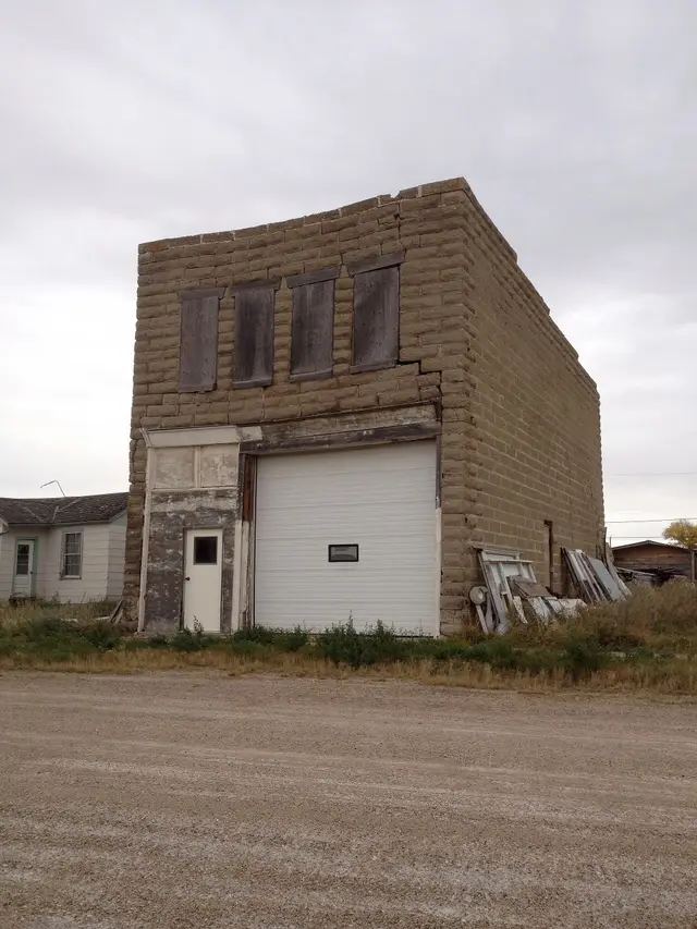 Abandoned brick building with boarded windows